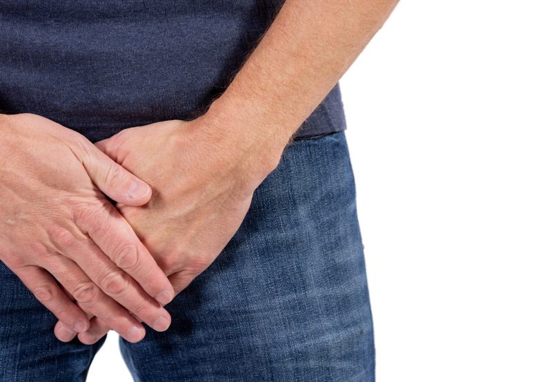 Man-holding-hands-over-enlarged-prostate-needing-BPH-treatment
